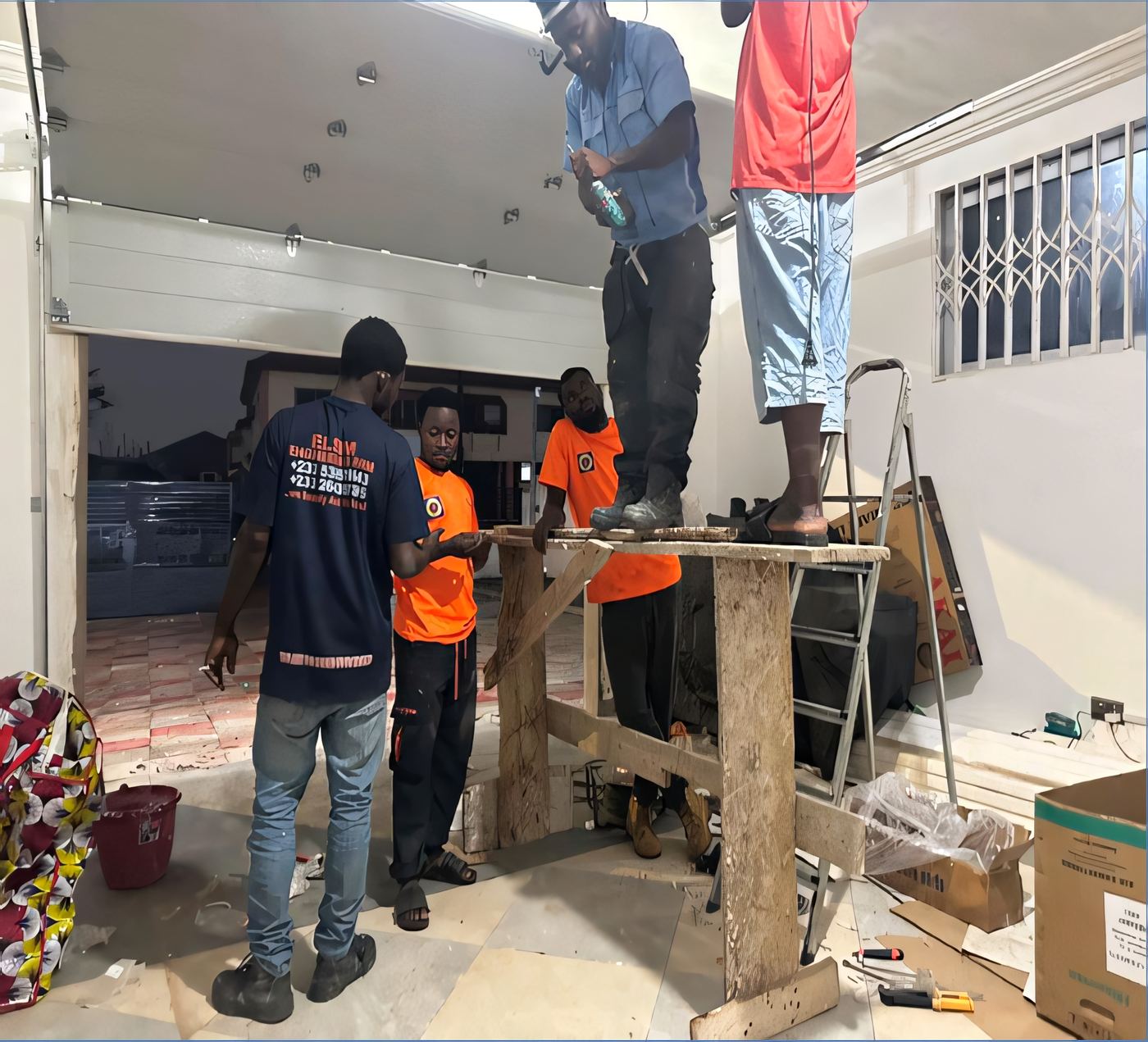 ELSIM electrician on scaffolding installing wiring on a residential building