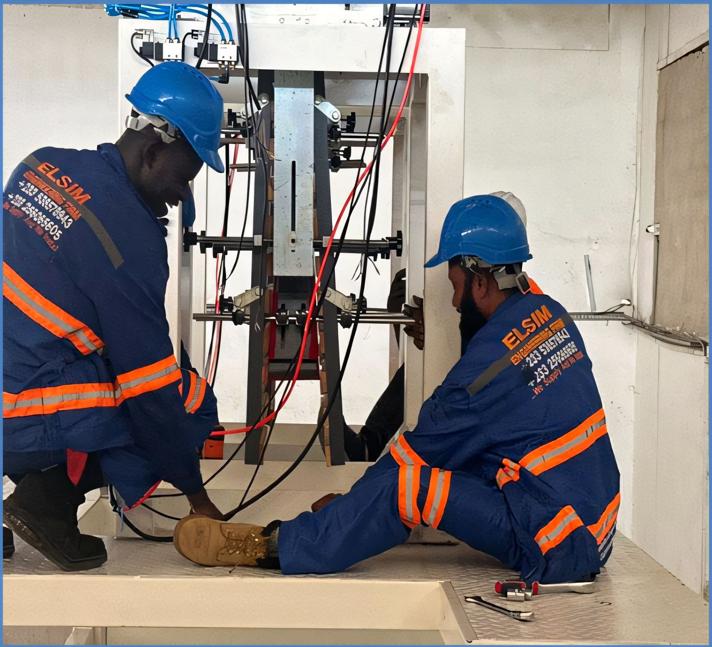 ELSIM technicians working inside a lift shaft installing electrical services