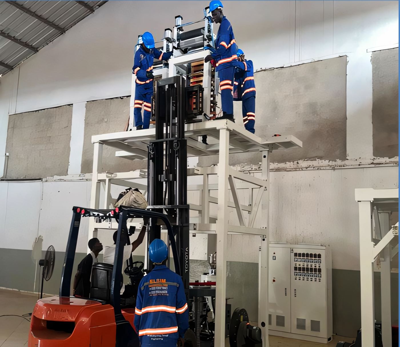 ELSIM technicians assembling equipment on an elevated platform