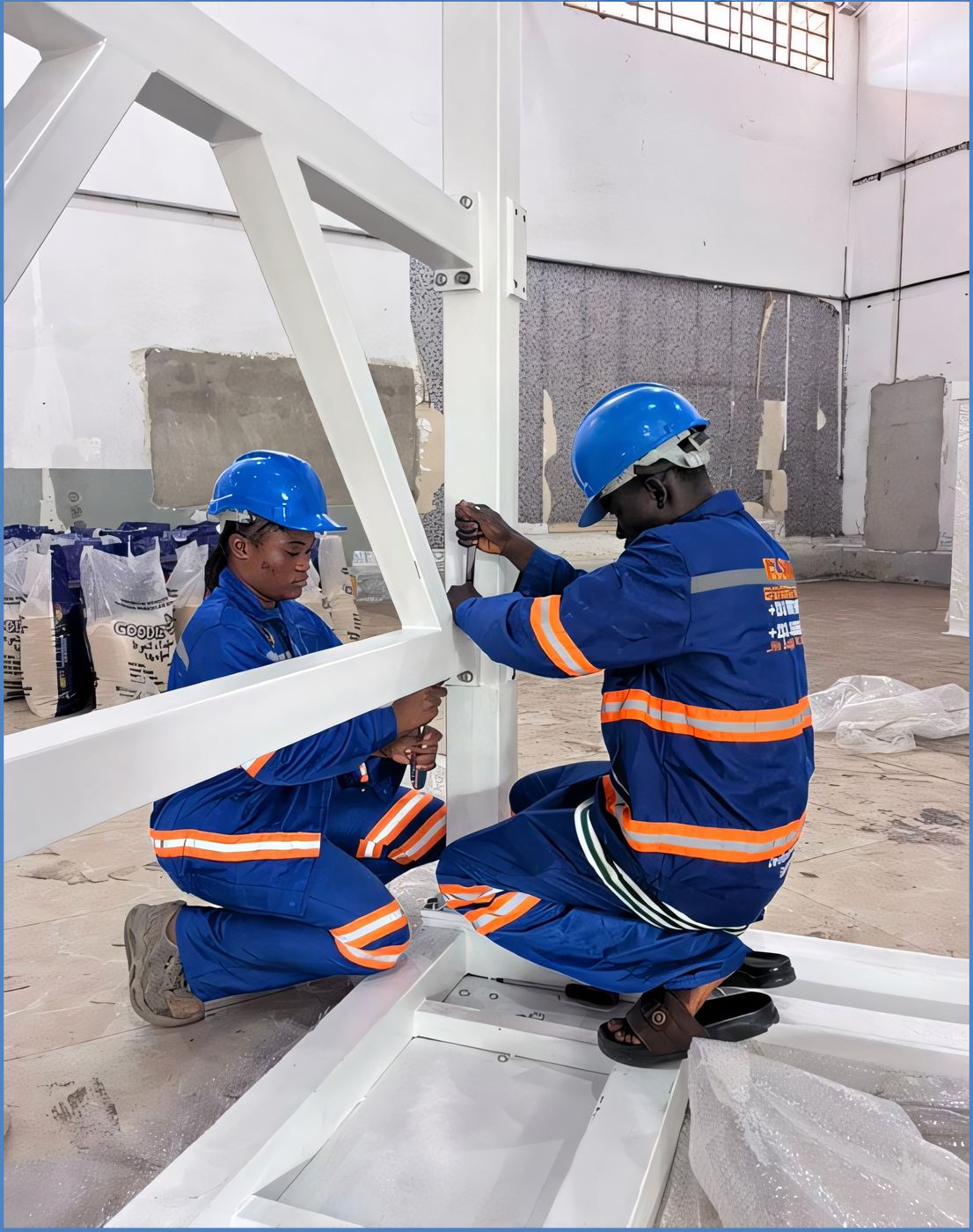 ELSIM technicians assembling a steel equipment frame